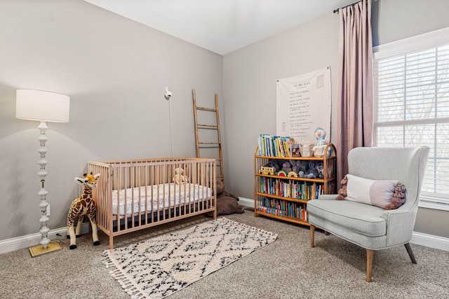 bedroom featuring a nursery area and carpet floors