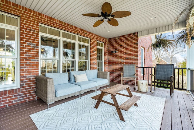 wooden deck with an outdoor living space and ceiling fan