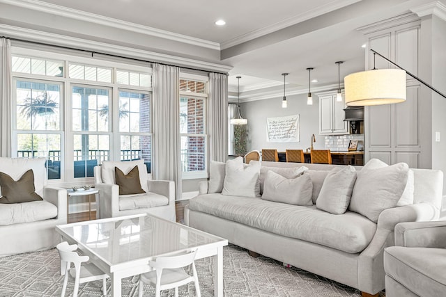 living room featuring ornamental molding and sink