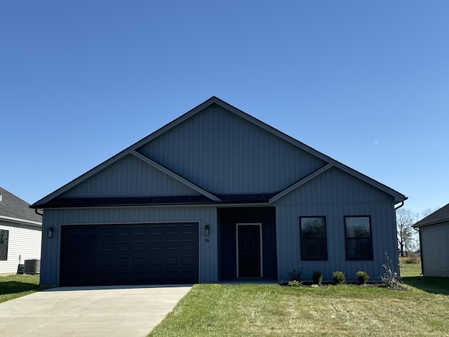 view of front of home with concrete driveway, a front lawn, an attached garage, and central air condition unit