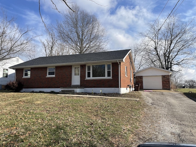 ranch-style house with a garage, an outbuilding, and a front yard