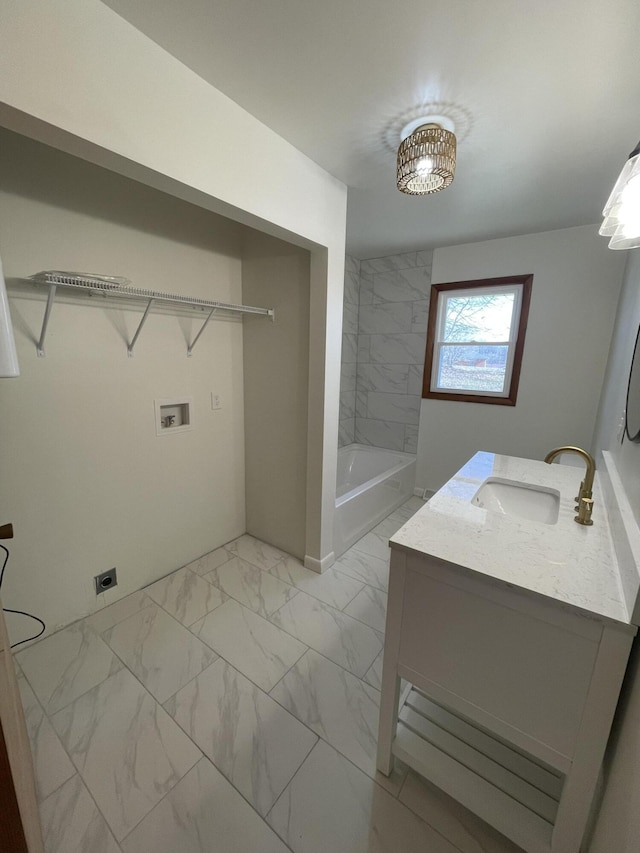 bathroom with tiled shower / bath combo and vanity