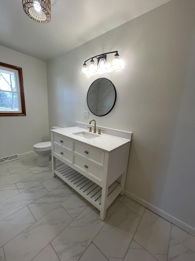 bathroom featuring vanity and toilet