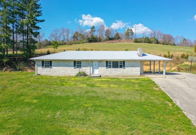 ranch-style house featuring a carport and a front lawn