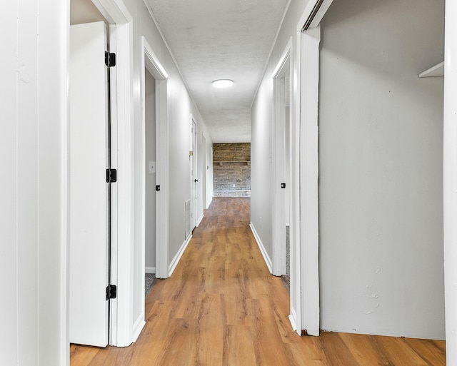 corridor with light wood-type flooring