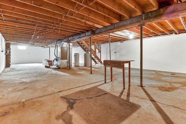 basement featuring water heater and heating unit