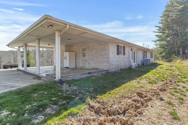 rear view of house with a yard, a patio, and central air condition unit