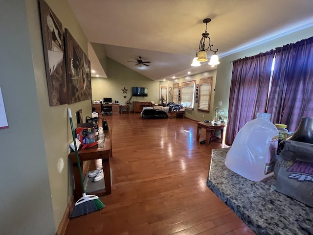 living room with hardwood / wood-style flooring, ceiling fan, and lofted ceiling