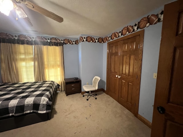 carpeted bedroom with ceiling fan and a closet