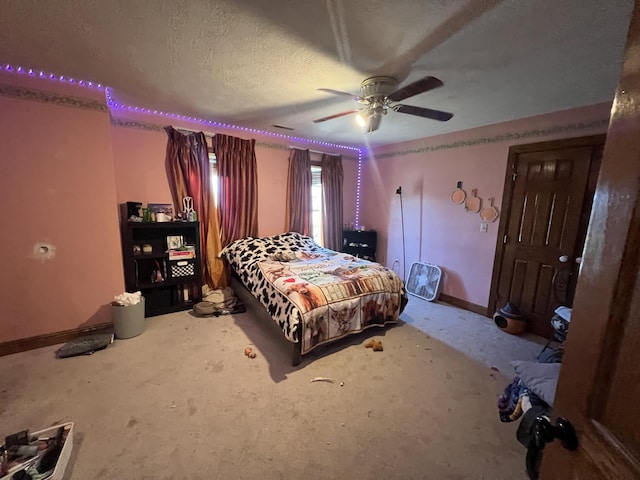 bedroom featuring ceiling fan, carpet, and a textured ceiling