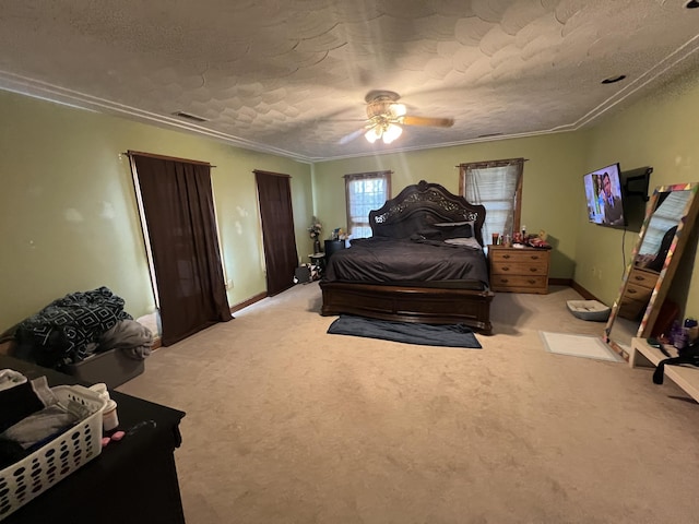 carpeted bedroom featuring ceiling fan and a textured ceiling