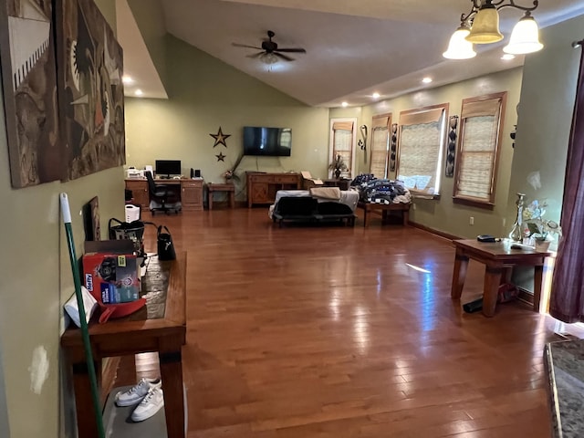 living room featuring hardwood / wood-style floors, vaulted ceiling, and ceiling fan