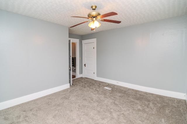 unfurnished room featuring ceiling fan, carpet, and a textured ceiling