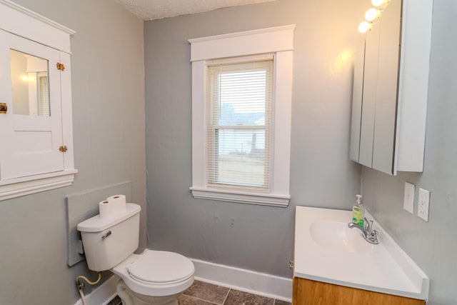 bathroom with tile patterned flooring, vanity, and toilet