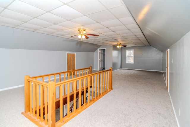 hall with vaulted ceiling, a paneled ceiling, and carpet floors