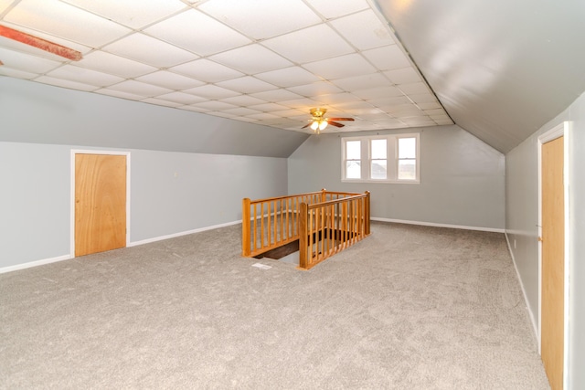 bonus room with ceiling fan, carpet flooring, and vaulted ceiling