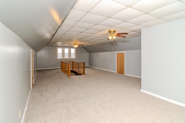 bonus room featuring lofted ceiling, carpet flooring, and ceiling fan