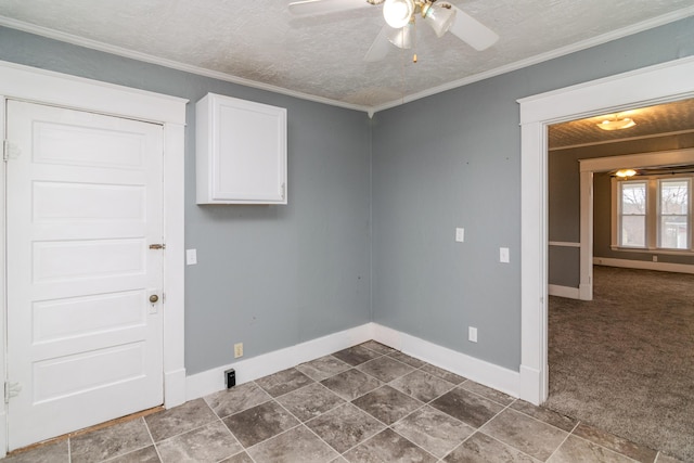 clothes washing area featuring ceiling fan, ornamental molding, a textured ceiling, and dark colored carpet