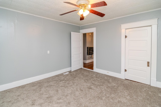 unfurnished bedroom featuring heating unit, ceiling fan, ornamental molding, and carpet