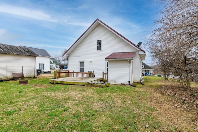 back of house with a deck and a lawn