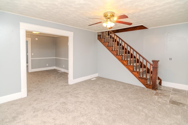 unfurnished room featuring crown molding, light colored carpet, ceiling fan, and a textured ceiling