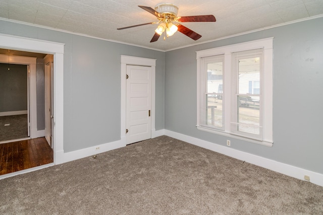 carpeted spare room with crown molding and ceiling fan