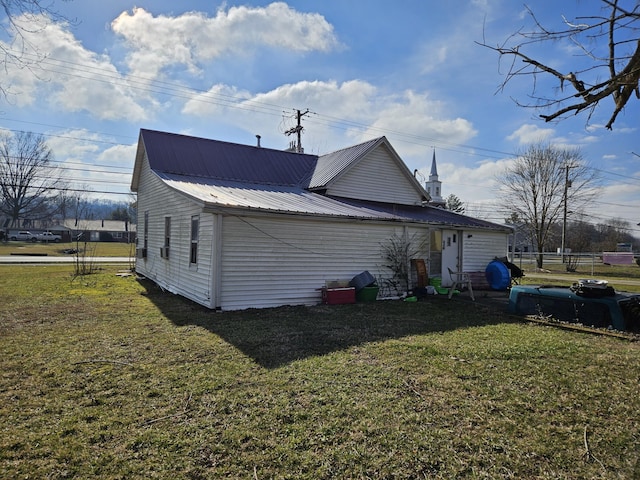 view of side of home with a lawn