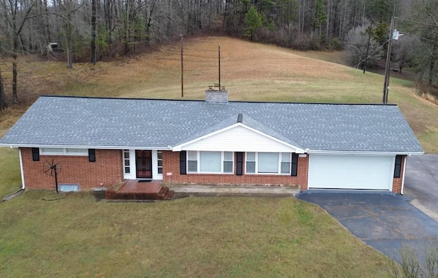 single story home with a garage and a front yard