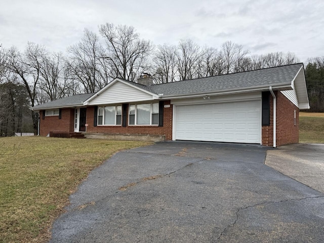 ranch-style home with a garage and a front lawn