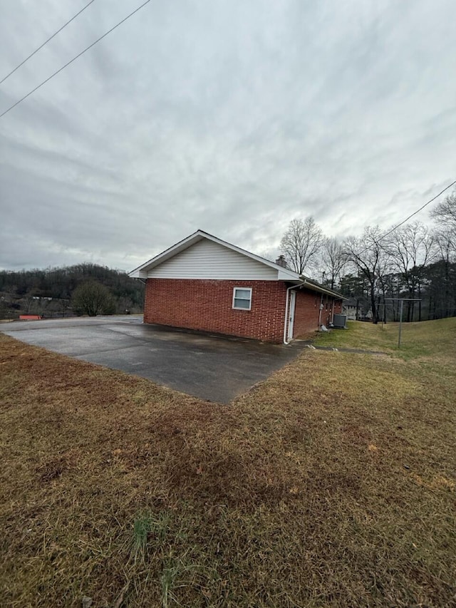 view of property exterior with a yard