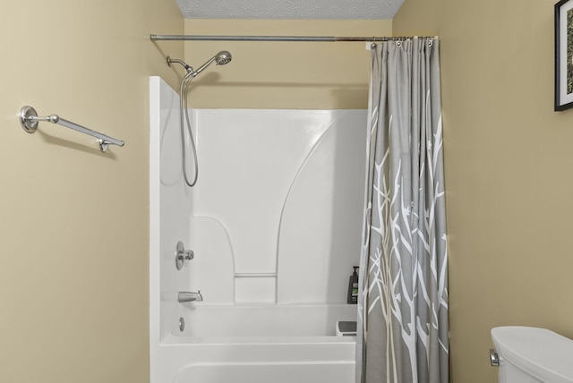 bathroom with shower / bath combo, a textured ceiling, and toilet