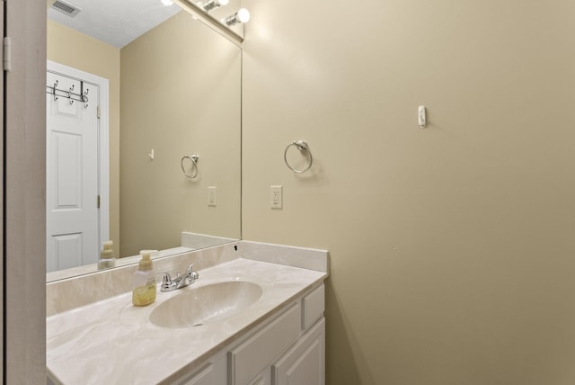 bathroom with vanity and a textured ceiling