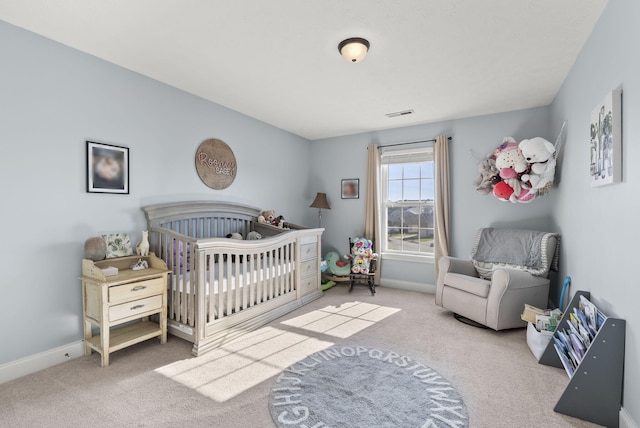 carpeted bedroom with a crib