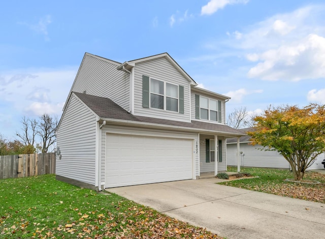 traditional home with a front lawn, driveway, an attached garage, and fence