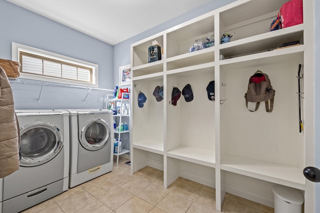 washroom with laundry area, light tile patterned floors, and independent washer and dryer