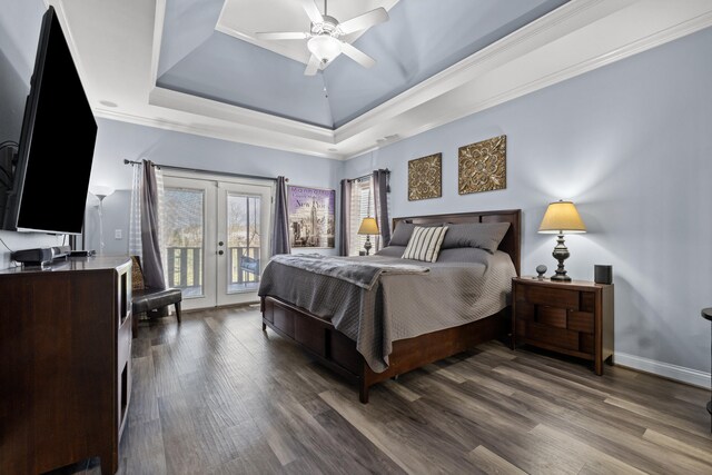 bedroom featuring access to outside, french doors, a raised ceiling, and dark wood-style flooring