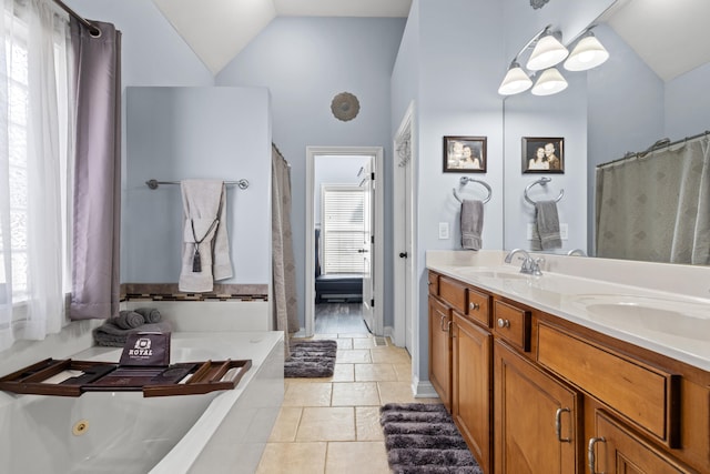 bathroom with double vanity, vaulted ceiling, and a sink