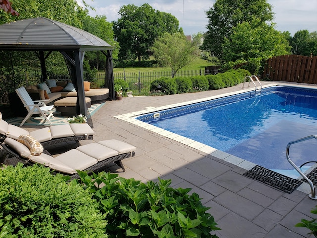 view of swimming pool with a fenced in pool, fence, a gazebo, and a patio