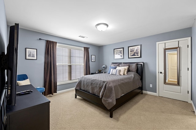 bedroom featuring light colored carpet, visible vents, and baseboards