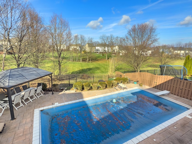 view of pool featuring a trampoline, a fenced in pool, a patio, a gazebo, and a fenced backyard