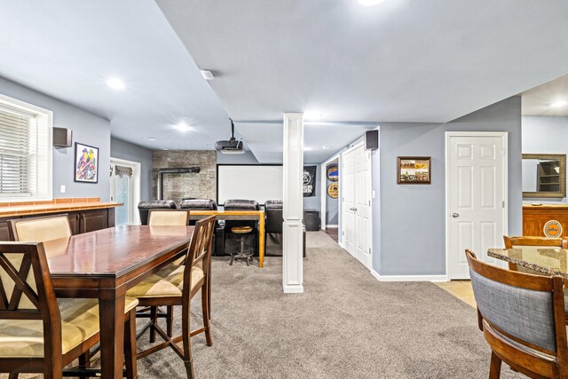 dining area with light carpet and baseboards