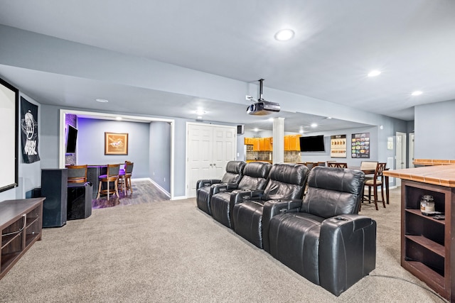 home theater with carpet floors, baseboards, a bar, and recessed lighting