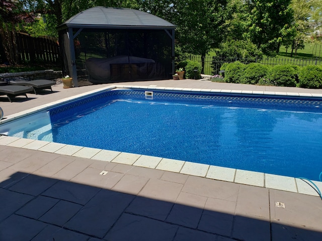 view of swimming pool featuring a gazebo, a fenced backyard, and a fenced in pool