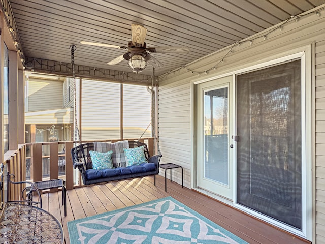 sunroom featuring ceiling fan