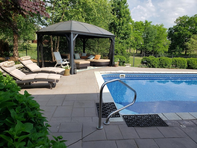 view of pool with a fenced in pool, a patio, fence, a gazebo, and an outdoor living space