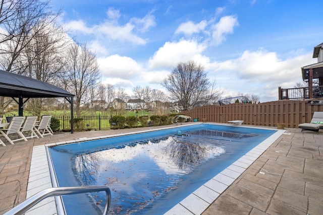 view of pool featuring a patio area, a fenced backyard, and a fenced in pool