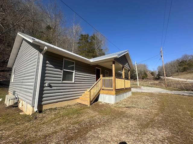 view of front facade with central AC unit and covered porch