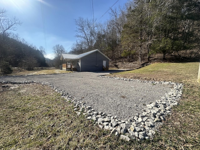 view of side of home with a yard