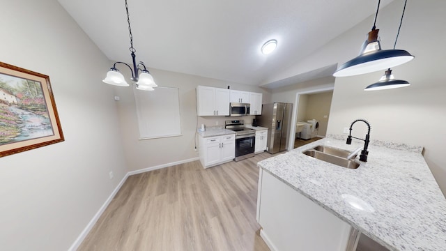 kitchen featuring pendant lighting, sink, stainless steel appliances, light stone counters, and white cabinets