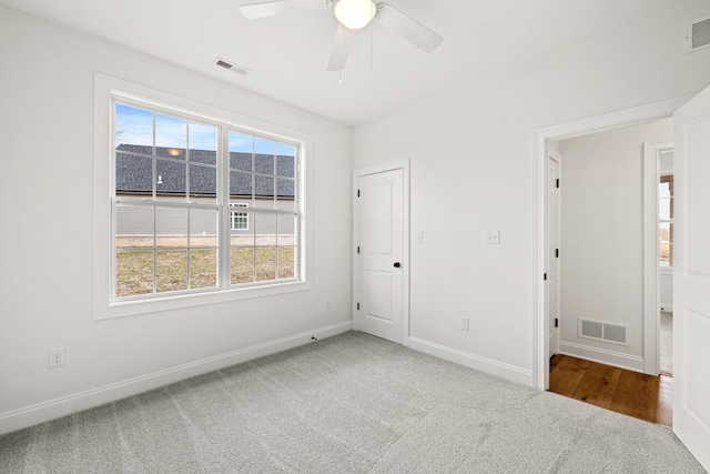 unfurnished room with ceiling fan and carpet flooring